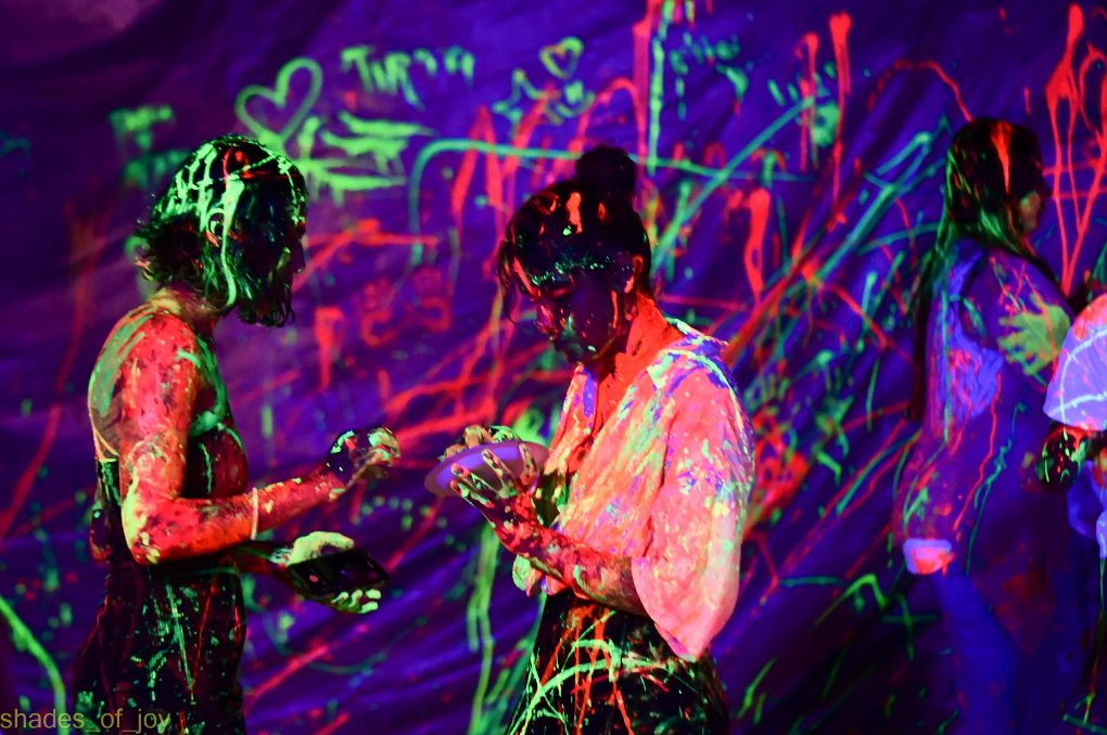 Guests enjoying neon luma paints at a neon paint party - Shore Club, An Bang Beach