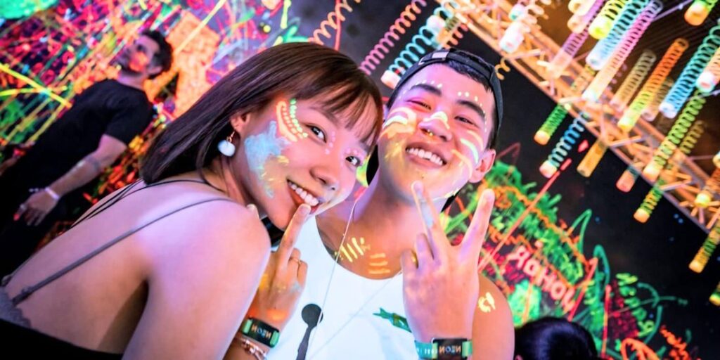 Paint your face with our free neon luma paints at Neon Waves Beach Party at Shore Club, An Bang Beach in Hoi An, Vietnam