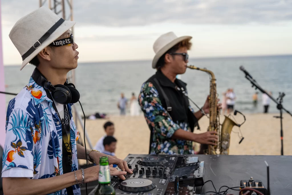 DJ Hee and saxophonist Mixen Hien performing a live sunset DJ set at Shore Club on An Bang Beach, Hoi An.